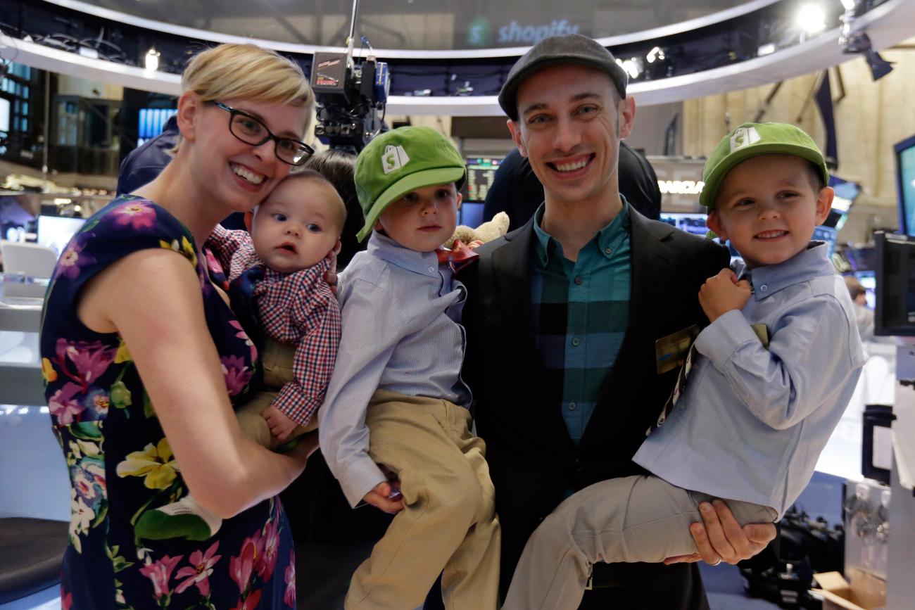 Tobias Lutke and his wife hold their three young boys.