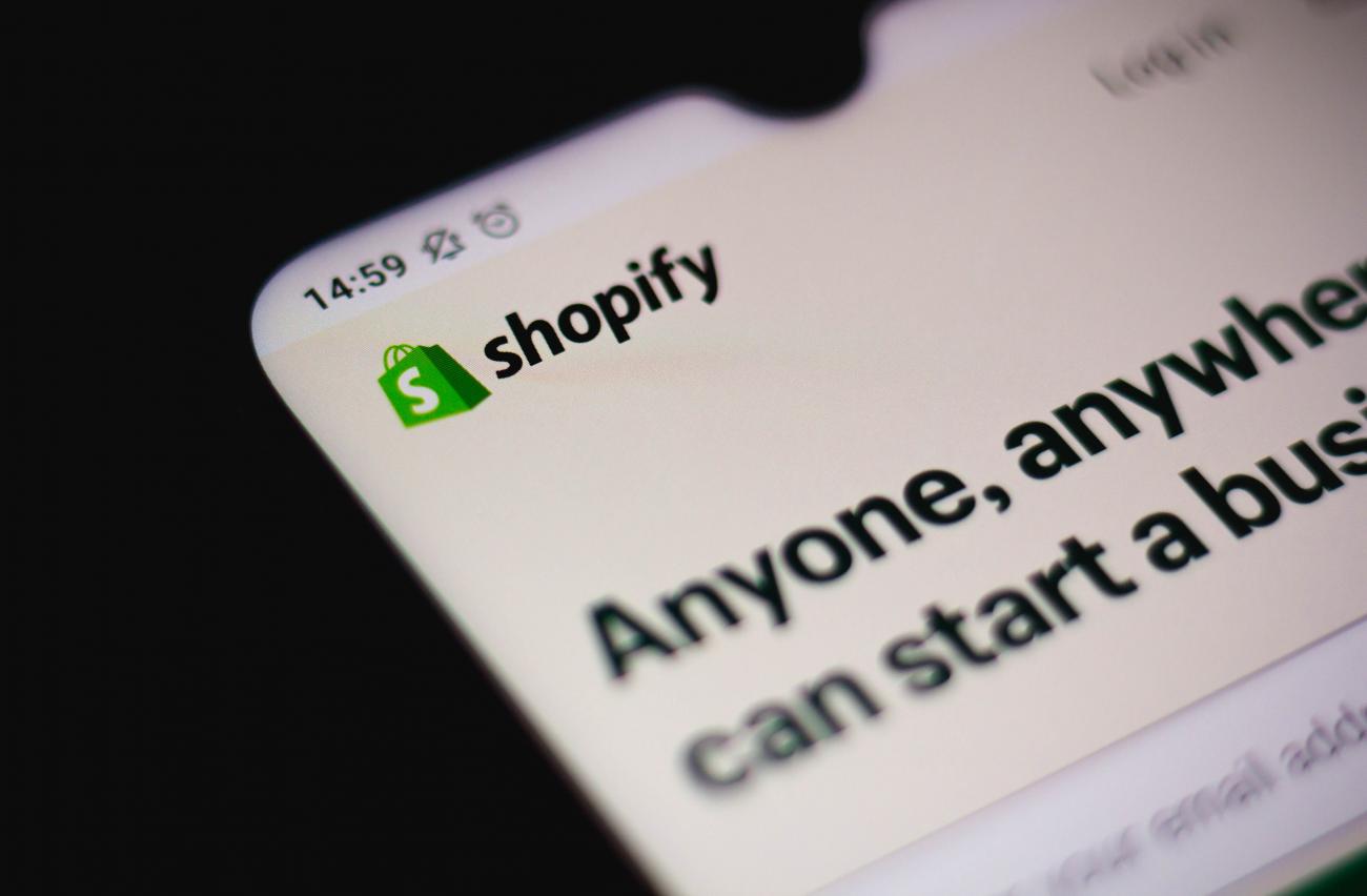 Close-up of Shopify logo on a mobile phone screen.