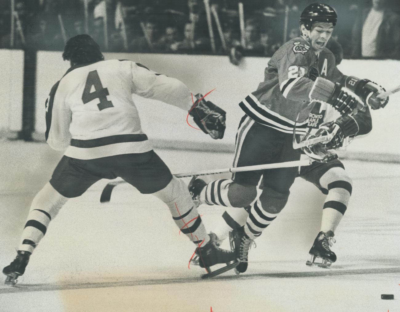 Stan Mikita tackles another hockey player.
