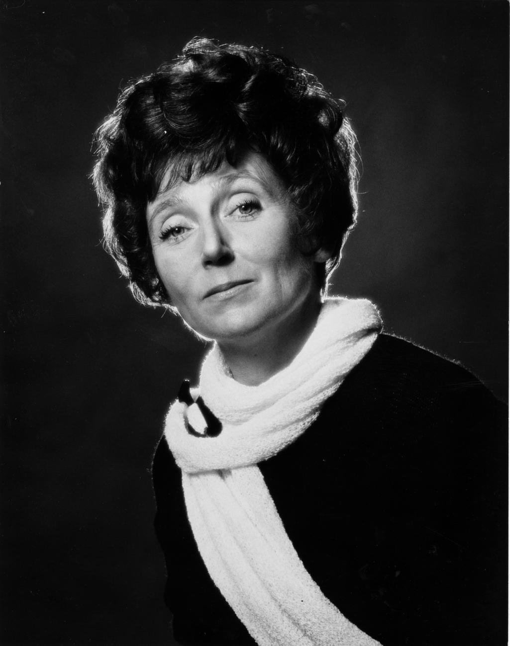 Ludmilla Chiriaeff posed in black and white photo wearing a white scarf.