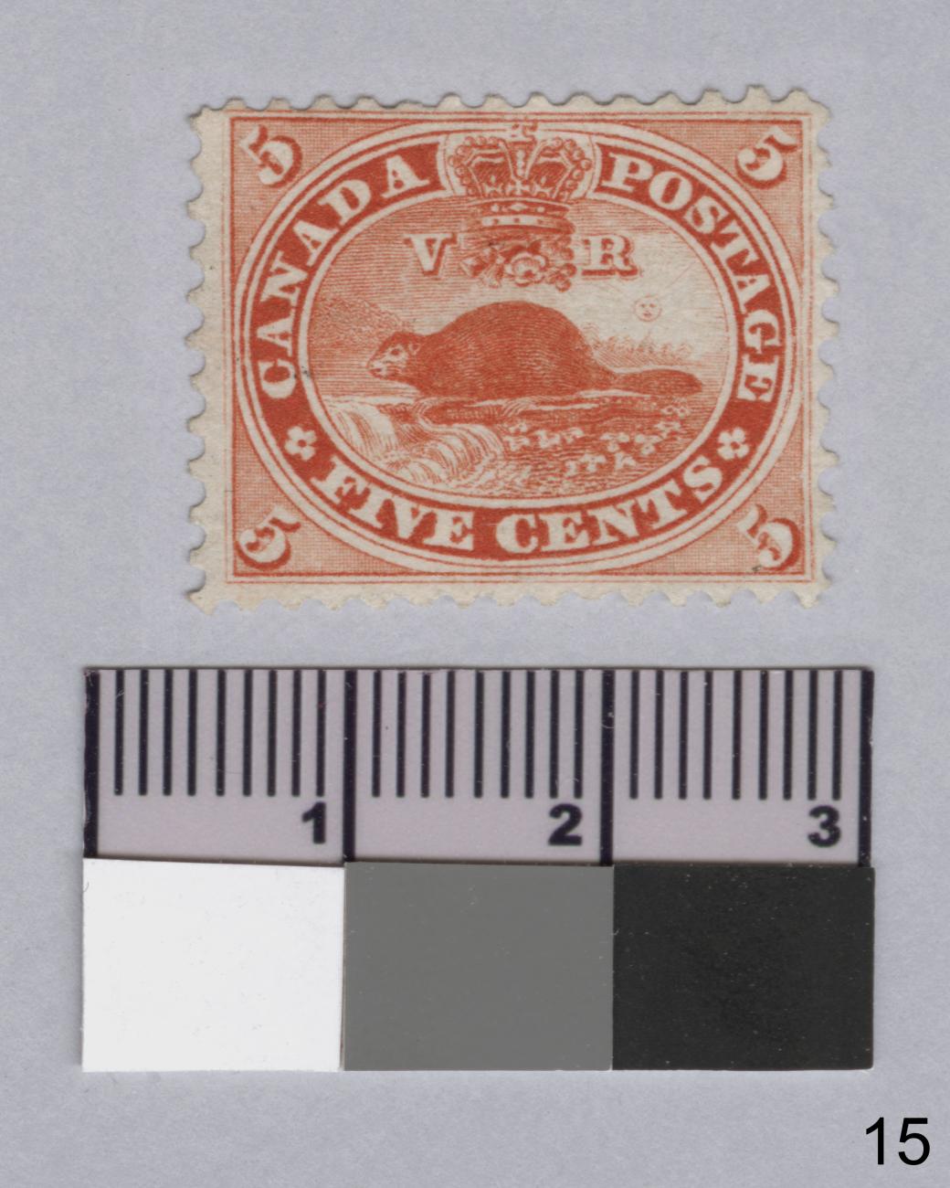 Photo of a postage stamp with a beaver picture and a ruler underneath for scale.