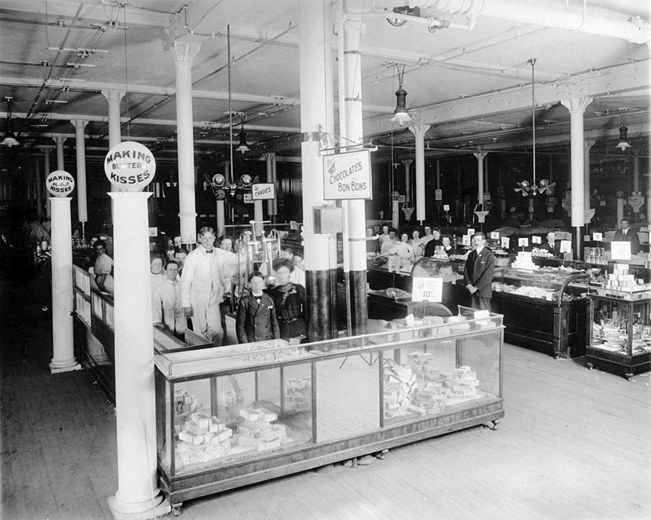 a shop counter with many staff standing behind it and in the background.