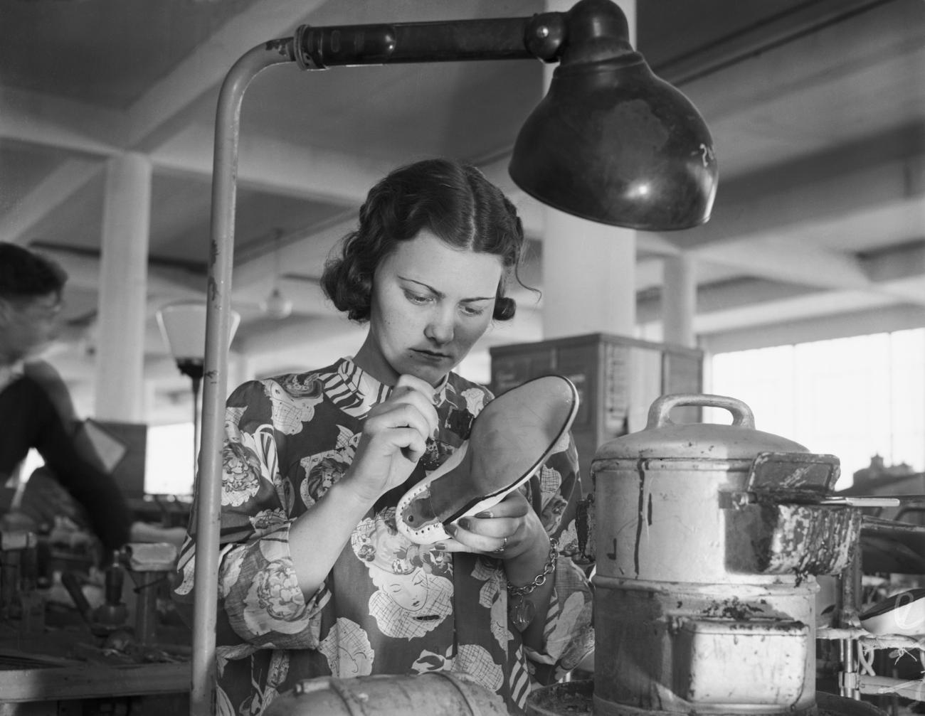 Woman making a shoe.